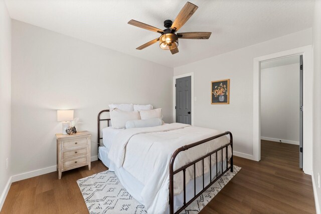 bedroom featuring dark hardwood / wood-style floors and ceiling fan