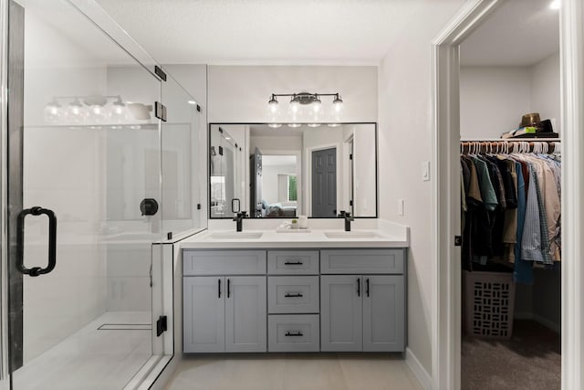 bathroom with vanity, an enclosed shower, and tile patterned flooring