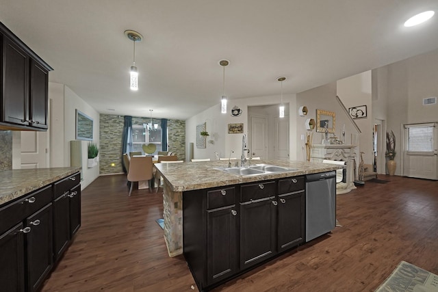 kitchen featuring hanging light fixtures, an island with sink, dishwasher, and sink