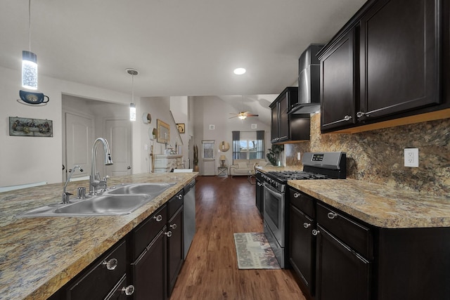 kitchen with sink, wall chimney range hood, dark hardwood / wood-style flooring, stainless steel appliances, and backsplash