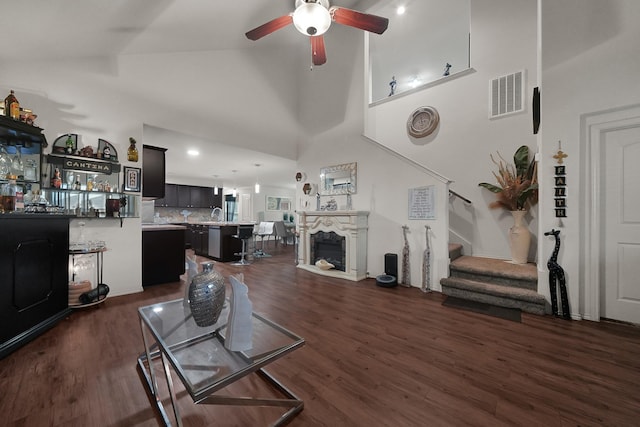 living room with high vaulted ceiling, dark hardwood / wood-style floors, and ceiling fan