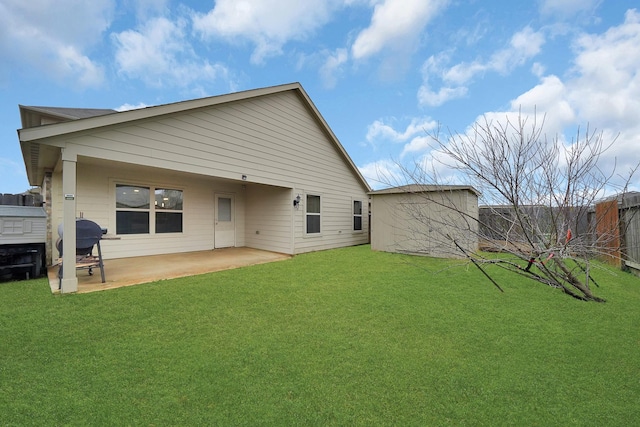 back of property featuring a yard and a patio area