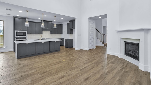 539 Oakview Bend Dr, Montgomery, TX 77316 - kitchen featuring built in microwave, oven, light wood-style floors, light countertops, and recessed lighting