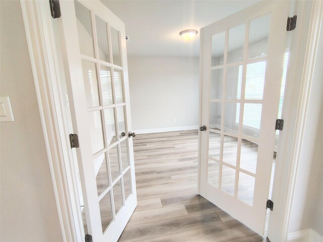 interior space with french doors and light wood-type flooring