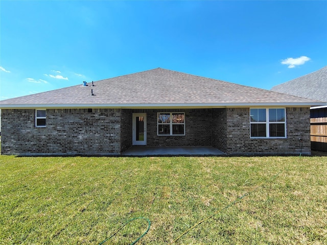 rear view of house featuring a yard and a patio