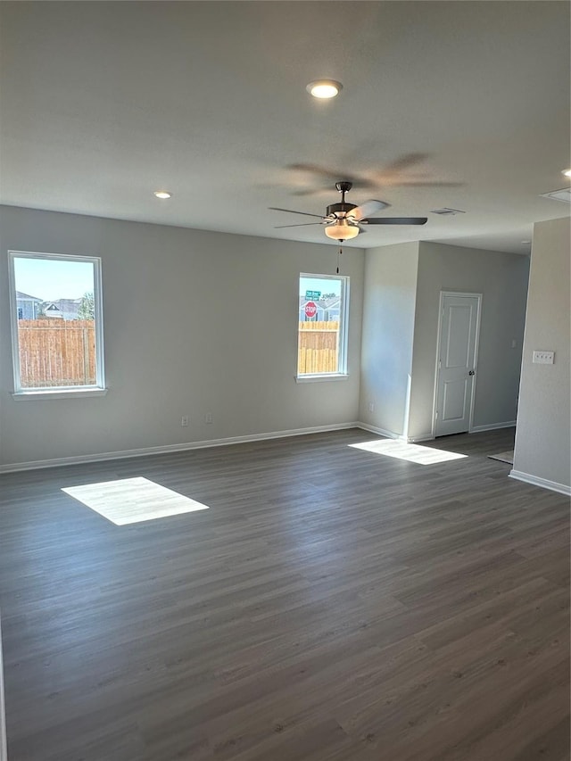 empty room with dark wood-type flooring and ceiling fan