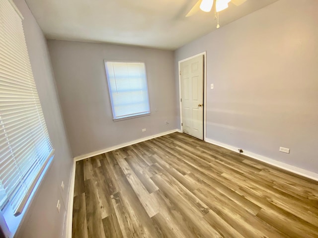 empty room featuring hardwood / wood-style flooring and ceiling fan