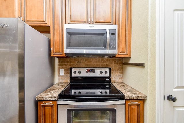 kitchen with tasteful backsplash, light stone countertops, and stainless steel appliances