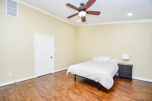 bedroom with ornamental molding, dark wood-type flooring, and ceiling fan