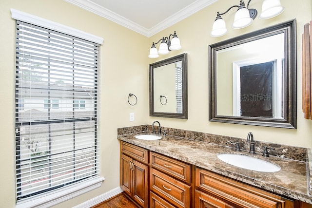 bathroom with ornamental molding and vanity