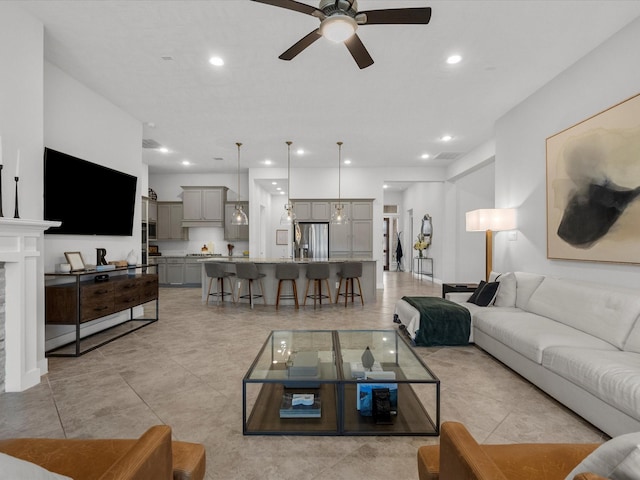 tiled living room with ceiling fan