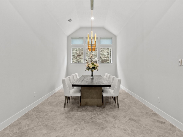 dining area featuring a chandelier and vaulted ceiling