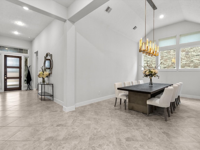 dining area featuring lofted ceiling, light tile patterned floors, a chandelier, and a healthy amount of sunlight