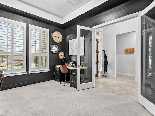 carpeted home office featuring french doors and a textured ceiling