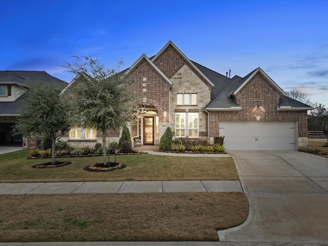 view of front facade featuring a garage and a lawn