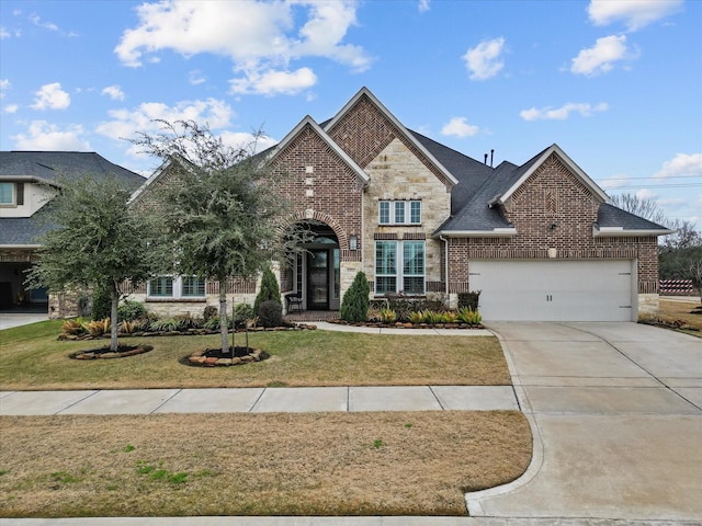 view of front of property with a garage and a front lawn