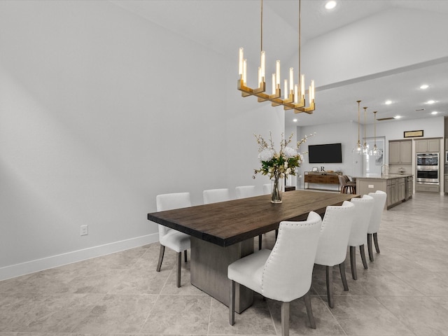 tiled dining space with vaulted ceiling and sink