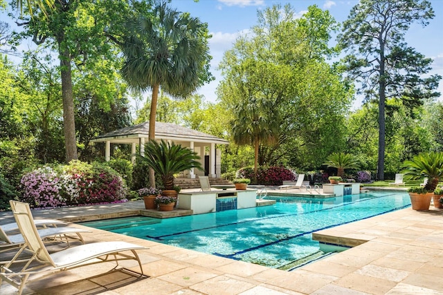 view of pool featuring an outbuilding and a patio area