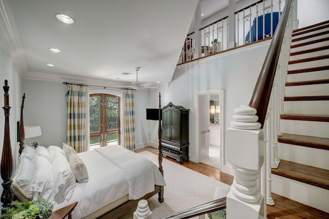 bedroom featuring french doors, ornamental molding, connected bathroom, and light hardwood / wood-style flooring