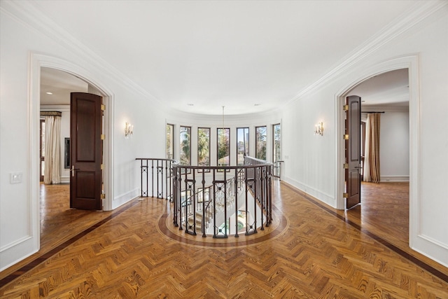 corridor with dark parquet flooring and ornamental molding