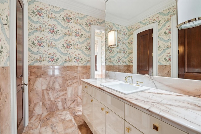 bathroom featuring tile walls, vanity, and crown molding