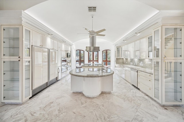 kitchen featuring lofted ceiling, sink, a center island, dishwasher, and backsplash