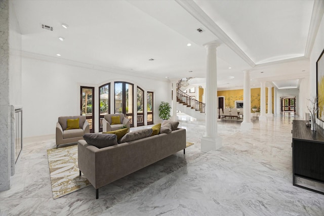 living room with ornamental molding and decorative columns