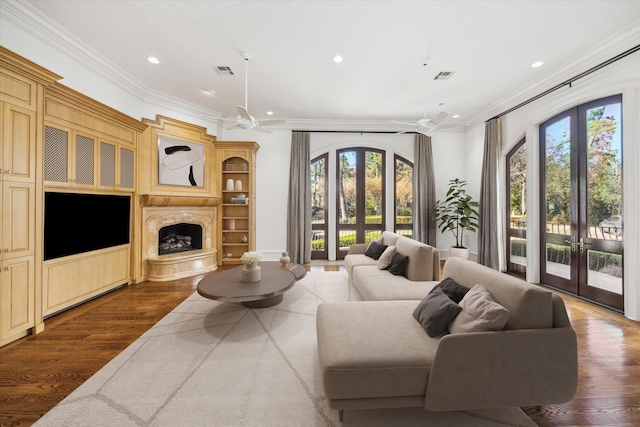 living room featuring dark wood-type flooring, french doors, and a healthy amount of sunlight