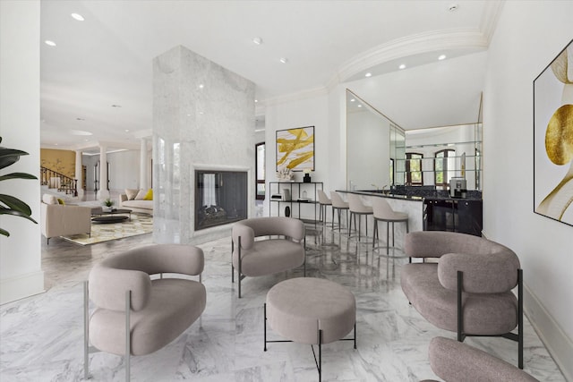 living room featuring a premium fireplace and ornamental molding