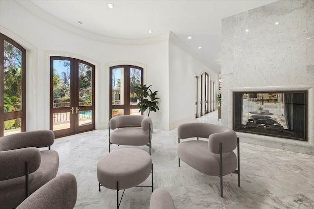 living room with ornamental molding, a fireplace, and french doors