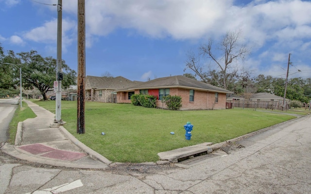 single story home featuring a front yard