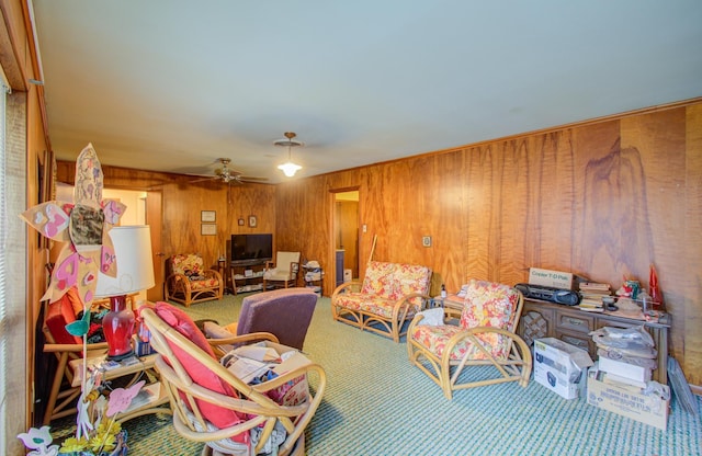 interior space featuring ceiling fan, wooden walls, and carpet floors