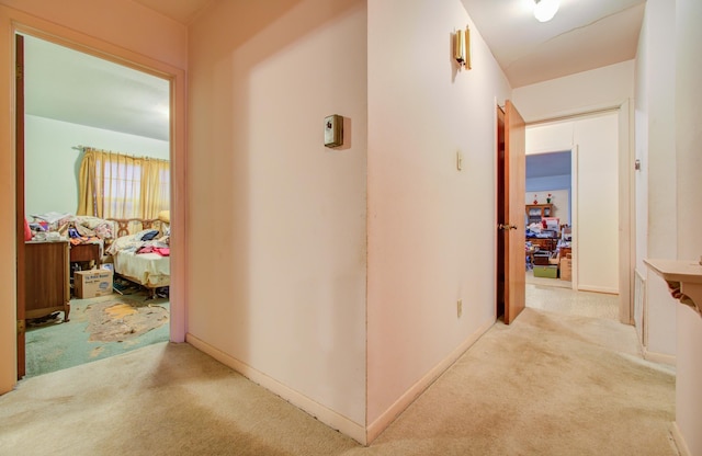 hallway with light colored carpet