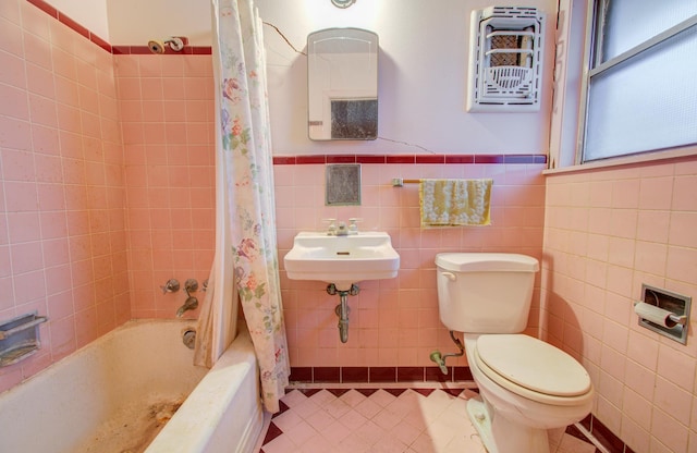 full bathroom featuring shower / bath combo, tile walls, tile patterned floors, and toilet