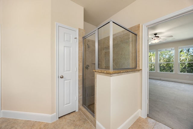 bathroom featuring walk in shower, ceiling fan, and tile patterned floors