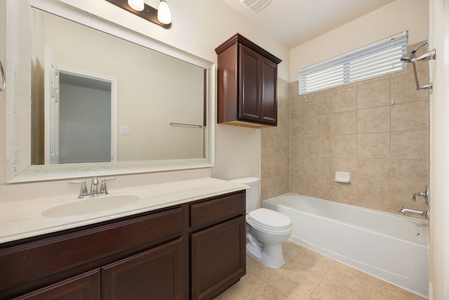 full bathroom with tiled shower / bath, vanity, toilet, and tile patterned flooring