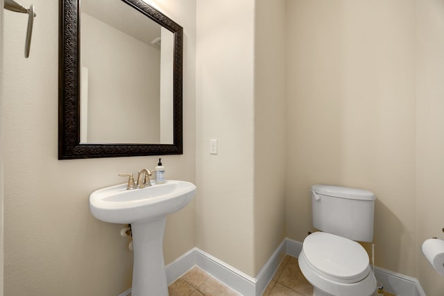 bathroom featuring tile patterned flooring and toilet