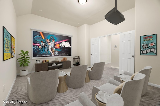 carpeted home theater room with lofted ceiling