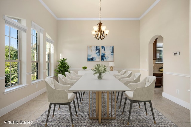 dining room with ornamental molding, light tile patterned floors, and an inviting chandelier