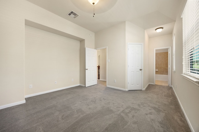 unfurnished bedroom featuring ensuite bathroom, carpet floors, and ceiling fan