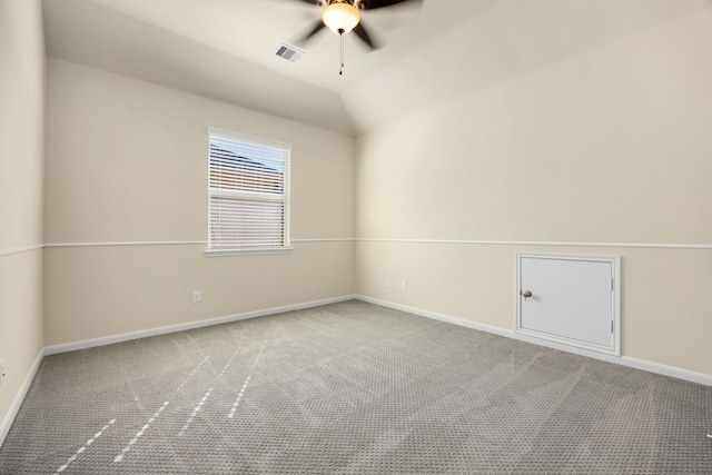 carpeted empty room with vaulted ceiling and ceiling fan