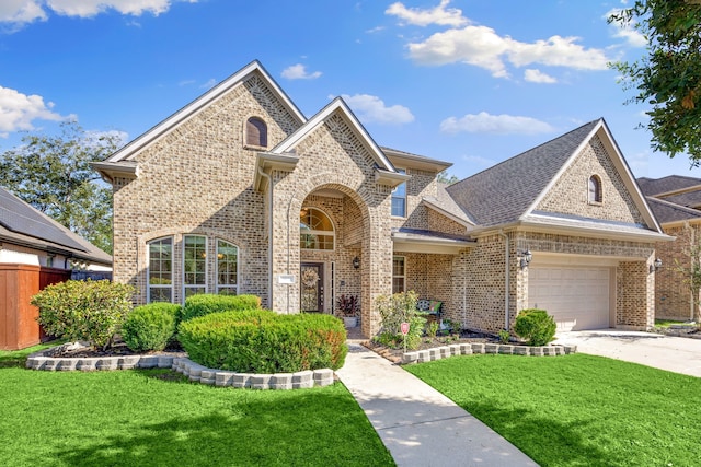 view of front of house featuring a garage and a front yard