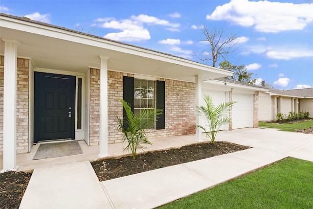 entrance to property with a garage and a porch