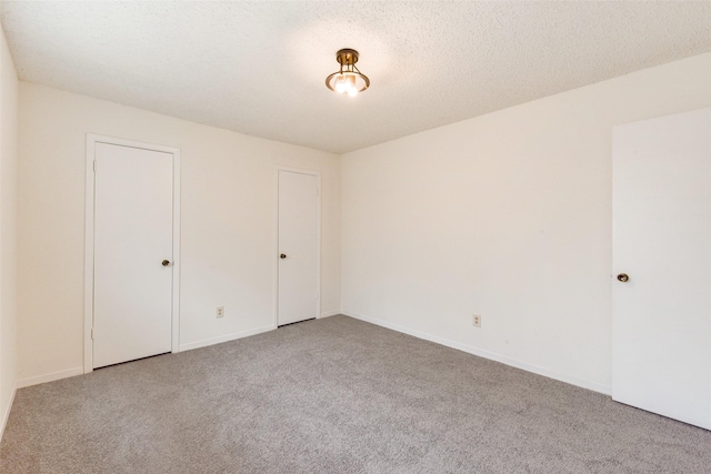 unfurnished bedroom with carpet and a textured ceiling