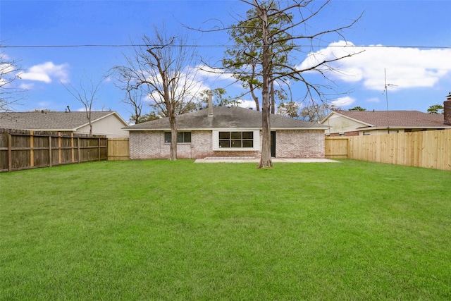 back of property with a patio and a lawn