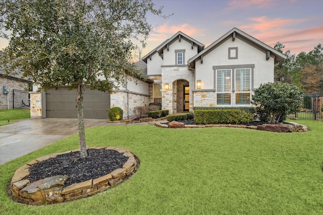 view of front of property with a garage and a yard