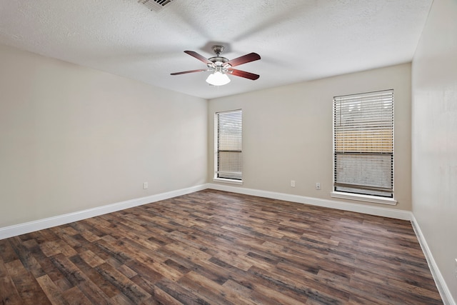 spare room featuring ceiling fan, dark hardwood / wood-style floors, and a textured ceiling