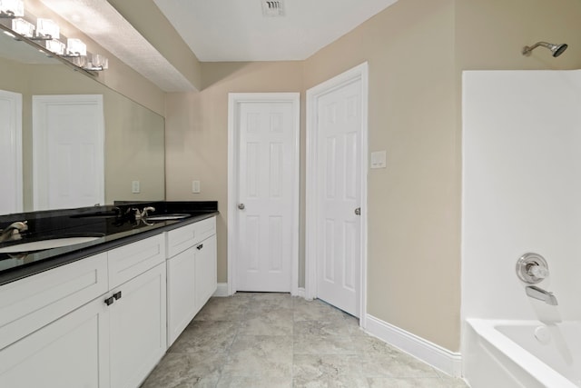 bathroom featuring vanity and shower / tub combination