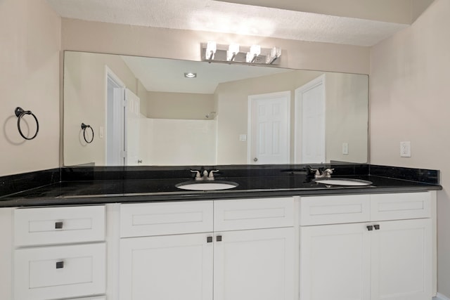 bathroom with vanity and a textured ceiling