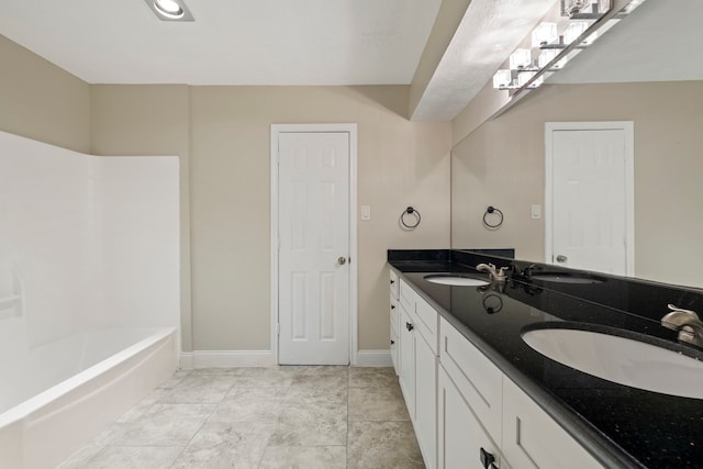 bathroom with vanity and a tub